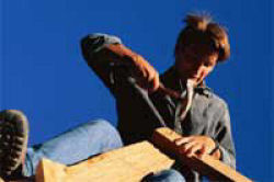 housing construction worker on top of building
